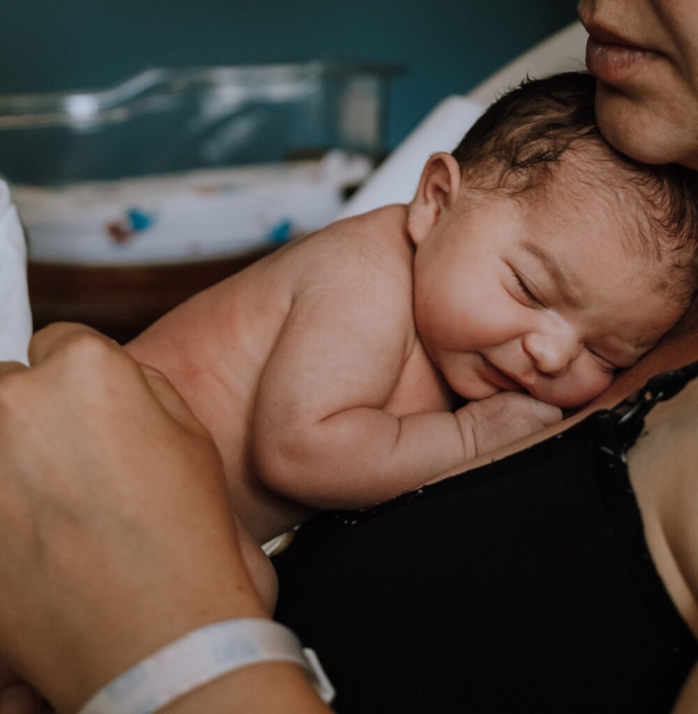 Newborn baby on mother's chest Astoria Oregon