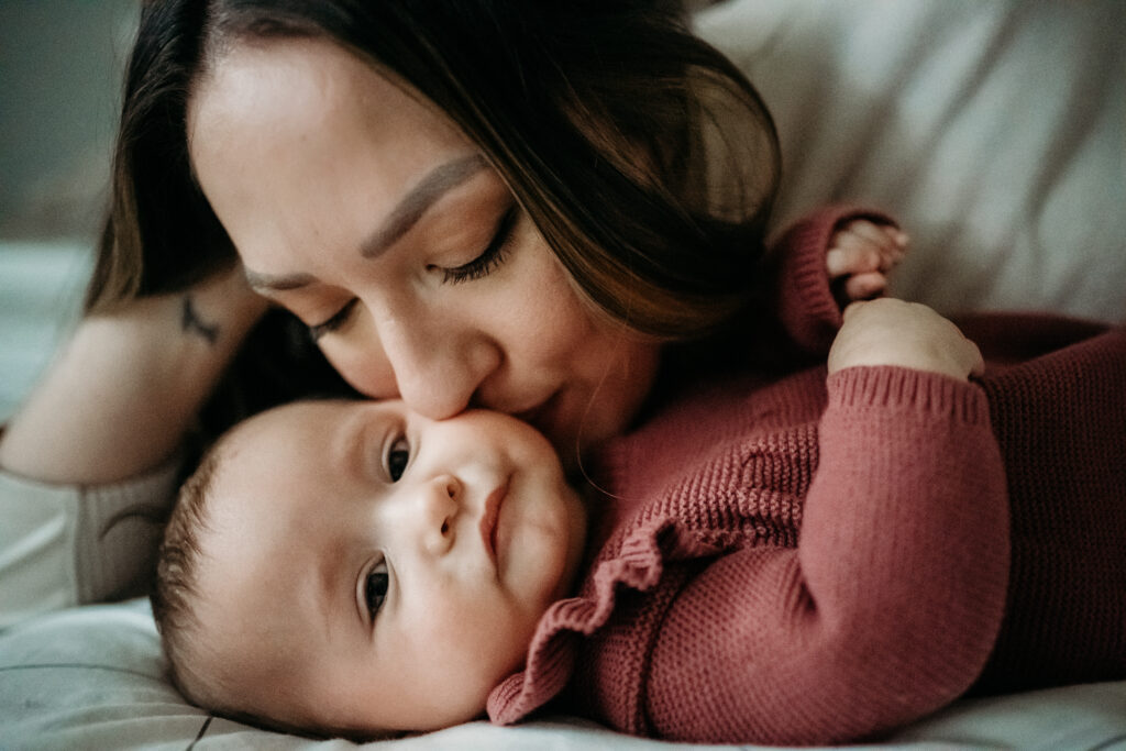 Mom kissing baby Portland Newborn Photographer