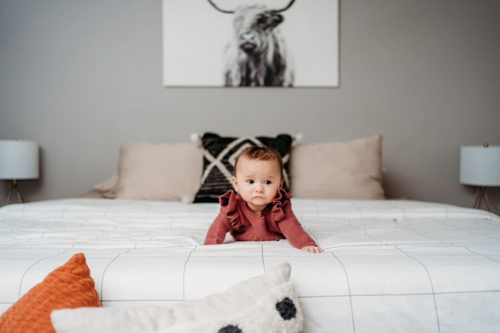 Baby on bed in home Portland Newborn Photographer